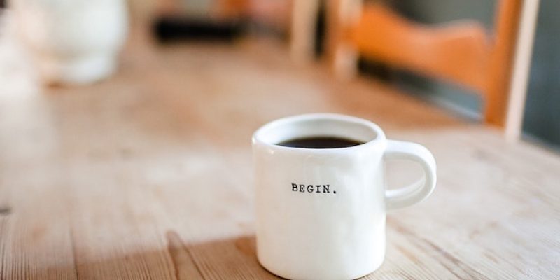 Mug of coffee on wooden table